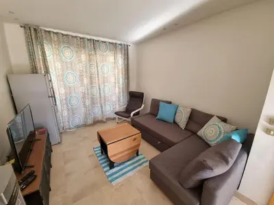 a living room with a couch and a chair at EL GOUNA Scarab Club One bedroom in Hurghada