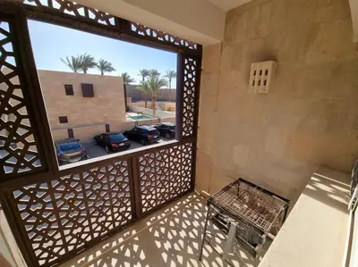 a balcony with a view of a parking lot with cars at EL GOUNA Scarab Club One bedroom in Hurghada