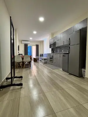 a large kitchen with a table and a refrigerator at Sea View Beach Access Princess Resort Hurghada in Hurghada