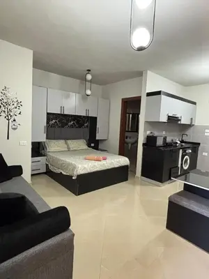 a living room with a bed and a kitchen at Sea View Beach Access Princess Resort Hurghada in Hurghada