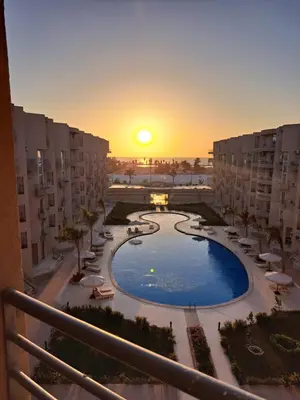 a view of a pool from a balcony of a resort at Sea View Beach Access Princess Resort Hurghada in Hurghada