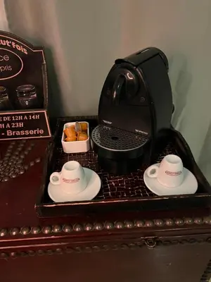 a black coffee maker with two cups on a tray at Villa du bonheur 202 in Hurghada