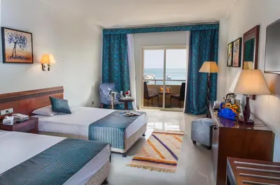 a hotel room with two beds and a view of the ocean at Salvatore Rooms- All Inclusive in Hurghada