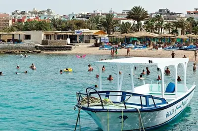 a boat sitting in the water at a beach at Salvatore Rooms- All Inclusive in Hurghada