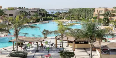 an overhead view of a swimming pool with palm trees at Salvatore Rooms-All Inclusive Makadi in Hurghada