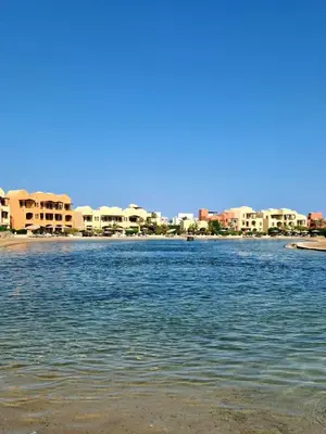 a body of water with buildings in the background at Cozy Studio Ground floor in Upper Nubia in Hurghada