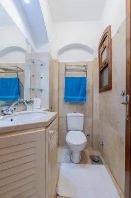 a bathroom with a toilet and a sink at Cozy Studio Ground floor in Upper Nubia in Hurghada
