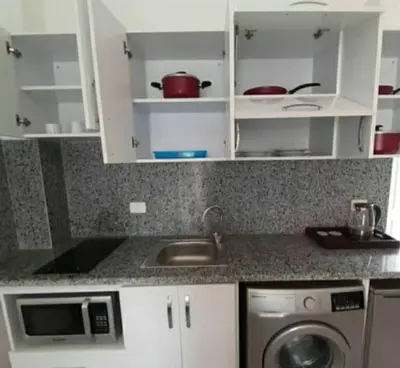 a kitchen with a sink and a washing machine at Hotel Room in Aqua Palms Hurghada in Hurghada