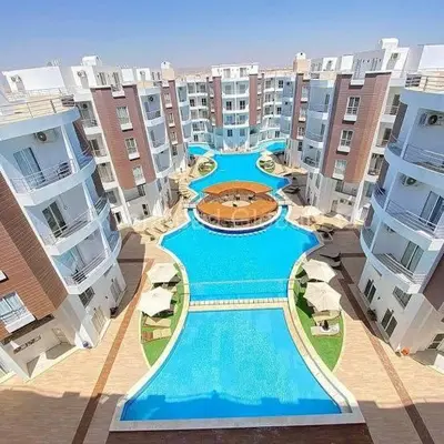 a large swimming pool in the middle of a building at Hotel Room in Aqua Palms Hurghada in Hurghada