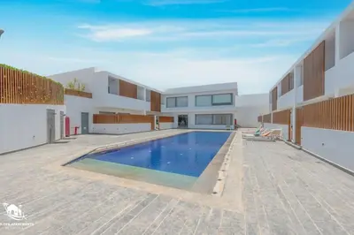 a swimming pool in the backyard of a house at New & Chic 2BR with Pool Access Sholan 2 El Gouna in Hurghada