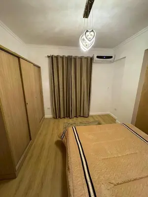 a bedroom with a bed and a window with a curtain at Luxurious heart flat in Hurghada