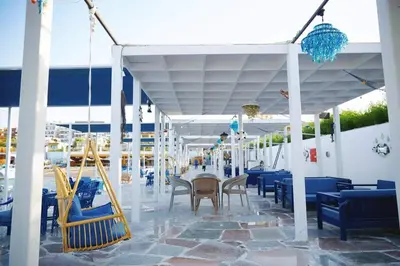 a patio with blue chairs and a table in a building at Luxurious heart flat in Hurghada