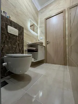 a bathroom with a toilet and a sink at Luxurious heart flat in Hurghada