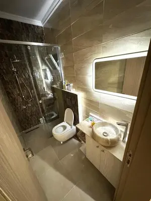 a bathroom with a toilet and a sink and a shower at Luxurious heart flat in Hurghada