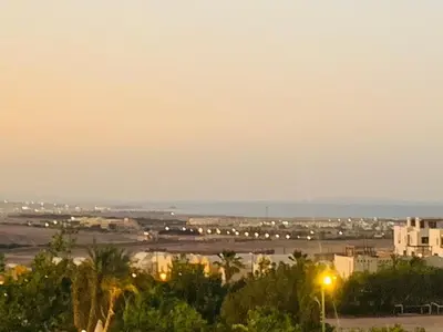 a view of a city at night with a street light at Makadi Heights lovely flat in Hurghada