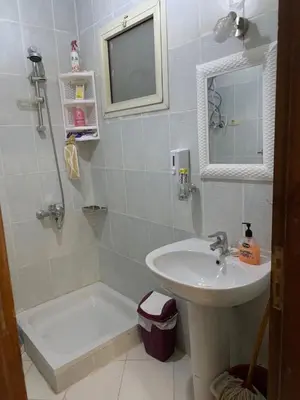 a bathroom with a sink and a toilet and a tub at Makadi Heights lovely flat in Hurghada