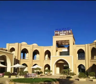 a large building with a sign on top of it at Makadi Heights lovely flat in Hurghada