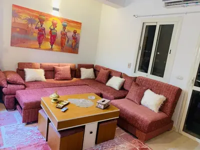 a living room with a couch and a table at Makadi Heights lovely flat in Hurghada