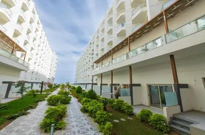 a building with a walkway between two tall buildings at Scanddic Resort Hurghada in Hurghada