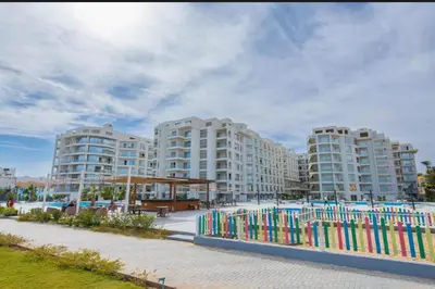 a row of apartment buildings with a colorful fence at Scanddic Resort Hurghada in Hurghada