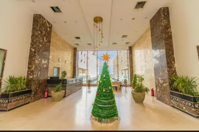 a christmas tree in the middle of a room with plants at Scanddic Resort Hurghada in Hurghada