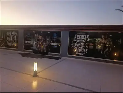 a wall with posters on the side of a building at Scanddic Resort Hurghada in Hurghada