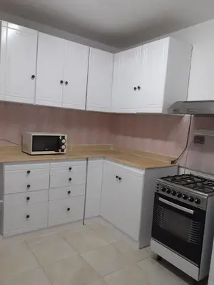 a kitchen with white cabinets and a stove at Villa Sara Touristic Center in Hurghada