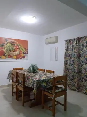a dining room with a table and chairs and a curtain at Villa Sara Touristic Center in Hurghada