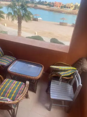 a balcony with chairs and a view of a beach at Westgolf y 62 1-8 in Hurghada