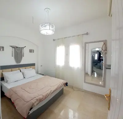 a bedroom with a large bed and a mirror at Westgolf y 62 1-8 in Hurghada