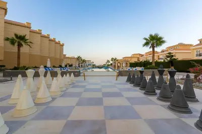 a checkerboard chessboard in front of a resort at Selena Bay Luxury Sea View 1BR Apartment, Private Beach and Pool in Hurghada
