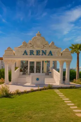 a white entrance to a building with palm trees at Selena Bay Luxury Sea View 1BR Apartment, Private Beach and Pool in Hurghada