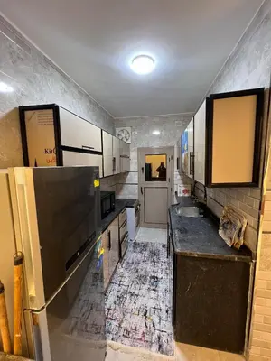 a kitchen with a sink and a refrigerator at Excellent residential unit in Shellal