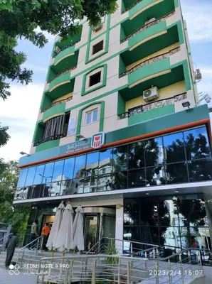 a building with two umbrellas outside of it at Excellent residential unit in Shellal