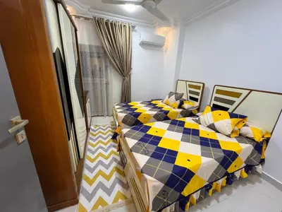 a bedroom with a bed with a yellow and blue at Excellent residential unit in Shellal