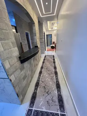 a hallway with a tile floor in a building at Excellent residential unit in Shellal