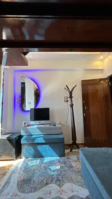 a living room with a purple light on the wall at Super Elite apartment - Aswan city center apartments in Aswan