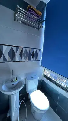 a bathroom with a white toilet and a sink at Super Elite apartment - Aswan city center apartments in Aswan