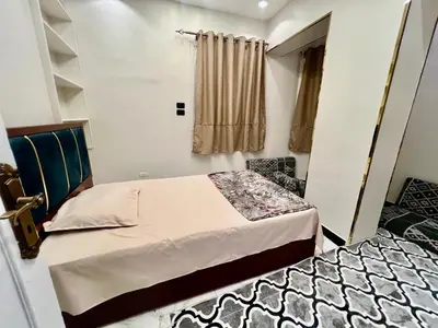 a small bedroom with a bed and a window at Super Elite apartment - Aswan city center apartments in Aswan