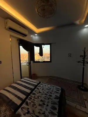 a bedroom with a bed in a room with a window at Super Elite apartment - Aswan city center apartments in Aswan
