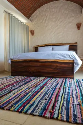 a bedroom with a large bed with a large rug at Klimatyczny apartament na dachu w sercu Hurghady in Hurghada
