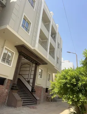 a building with a staircase in front of it at Star house apartments in Hurghada