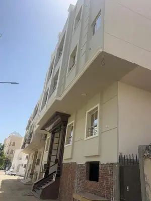 a large white building with a staircase on the side of it at Star house apartments in Hurghada
