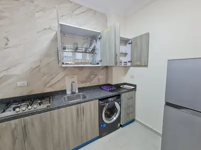 a kitchen with a sink and a washing machine at Star house apartments in Hurghada
