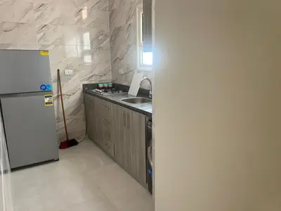 a kitchen with a white refrigerator and a sink at Star house apartments in Hurghada