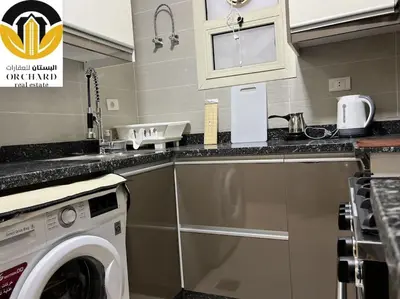 a kitchen with a washing machine and a sink at CAMUS 243, Princess Resort in Hurghada