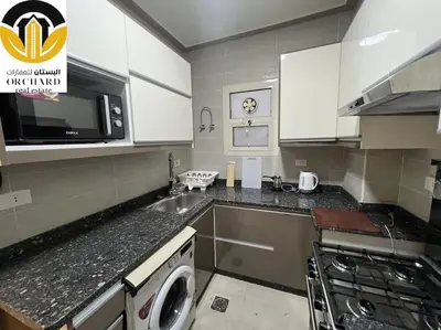a kitchen with a sink and a washing machine at CAMUS 243, Princess Resort in Hurghada