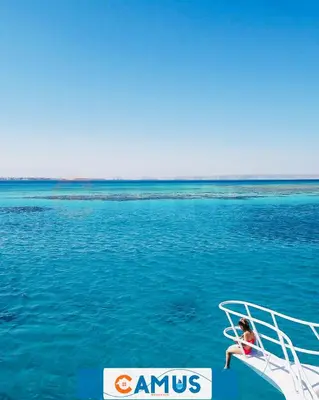 a child sitting on the back of a boat in the water at CAMUS 243, Princess Resort in Hurghada