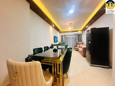 a living room with a table and chairs and a couch at CAMUS 243, Princess Resort in Hurghada