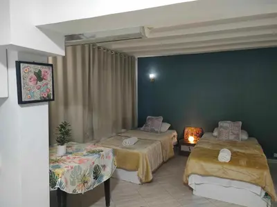 a room with two beds and a table with a lamp at comfort marine 2 in Hurghada